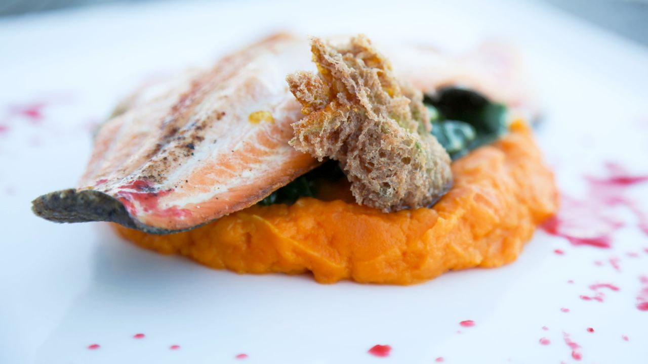 <strong>Pueblo Harvest Café, Albuquerque, New Mexico:</strong> This pan-seared New Mexico trout is served with a yam purée, wild greens, prickly pear syrup and fried squash. 