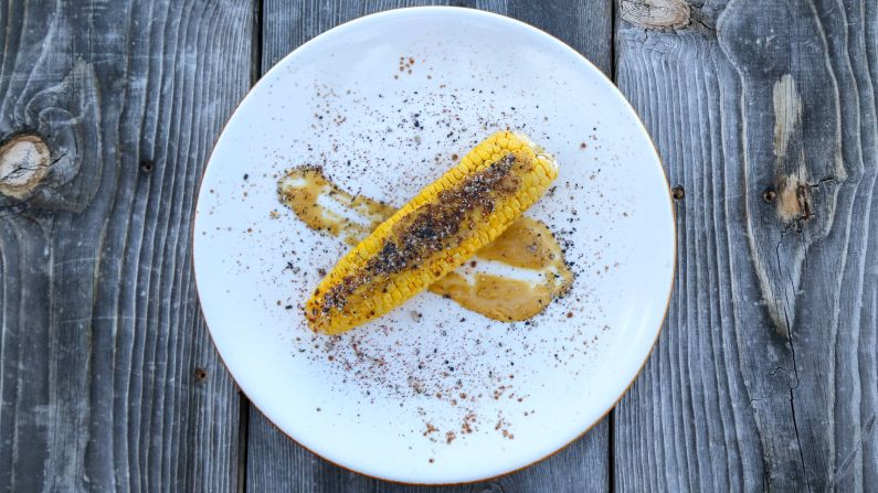 <strong>Pueblo Harvest Café:</strong> This elote, or grilled  local corn is seasoned with squash butter, sumac and black  bean salt. 