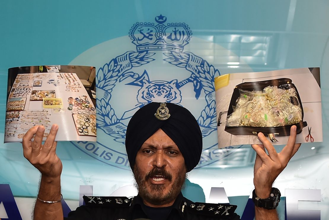 Malaysian Police Commercial Crime Investigation Department (CCID) Director Amar Singh shows pictures of seized items from Najib's properties while addressing media in Kuala Lumpur on June 27.