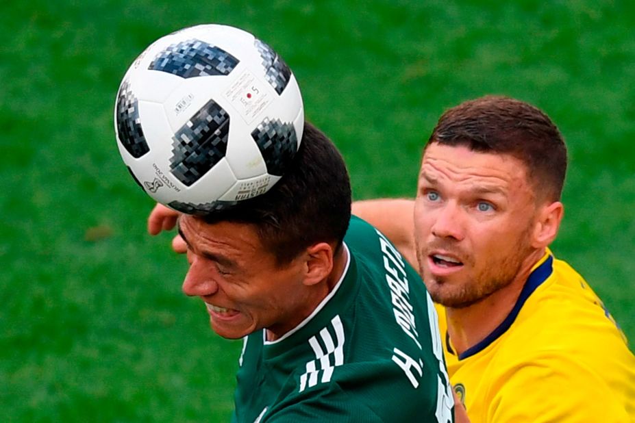 Mexican defender Hector Moreno heads the ball in front of Swedish forward Marcus Berg.