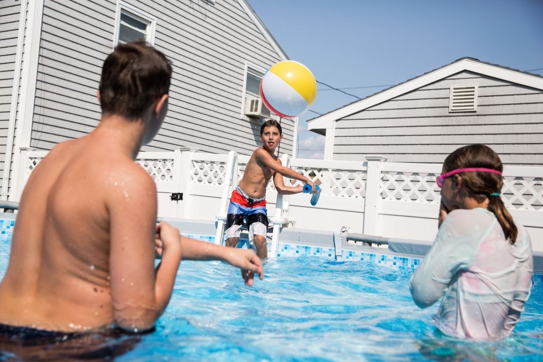 Trevor plays with his brother and sister, Toby and Bristel, in the swimming pool at their grandparents' house. The family swims together every weekend in the summer and uses the time together to bond. 