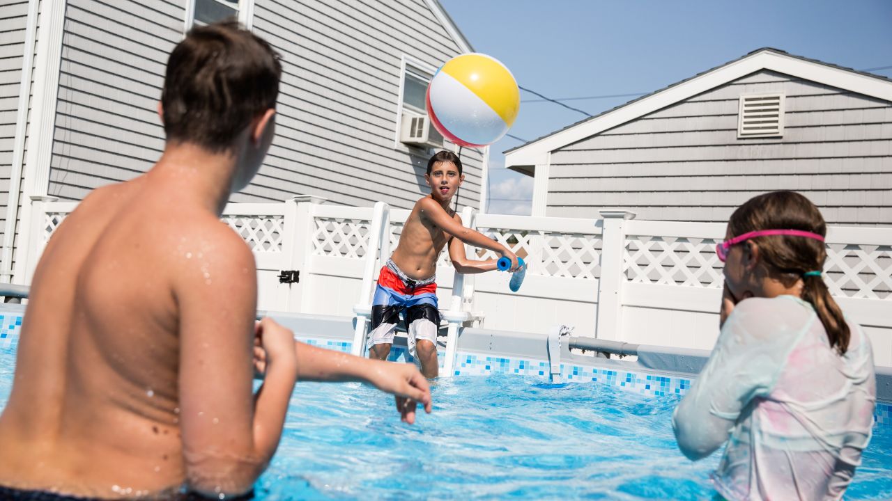 Trevor plays with his brother and sister, Toby and Bristel, in the swimming pool at their grandparents' house. The family swims together every weekend in the summer and uses the time together to bond. 