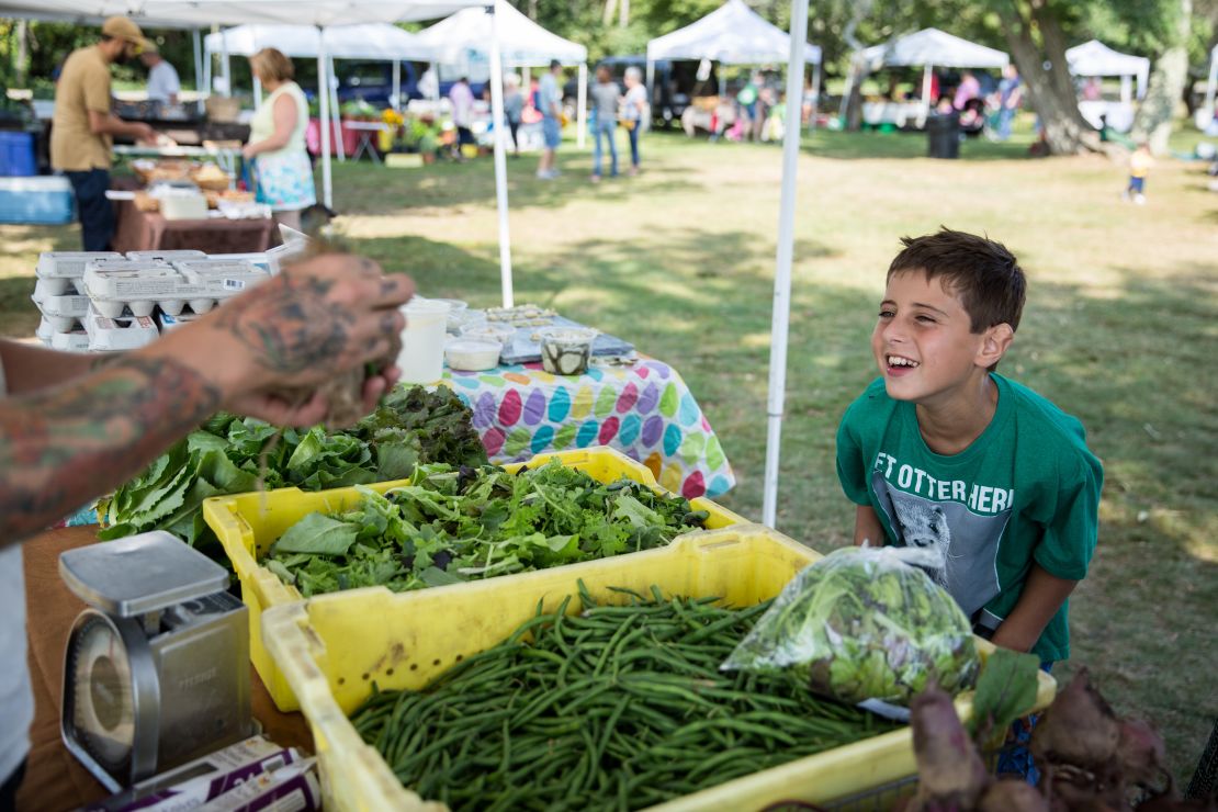 Trevor has an array of speech and processing issues. Despite his disabilities, he still enjoys life, including this visit to a local farmers market. 