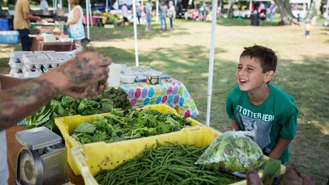 Trevor has an array of speech and processing issues. Despite his disabilities, he still enjoys life, including this visit to a local farmers market. 