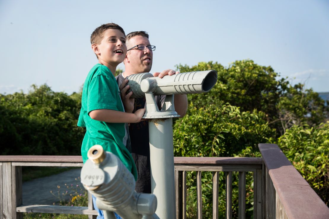 Trevor and his dad take in the views during a hike in the Sachuest Point Wildlife Refuge in Middletown, Rhode Island. 