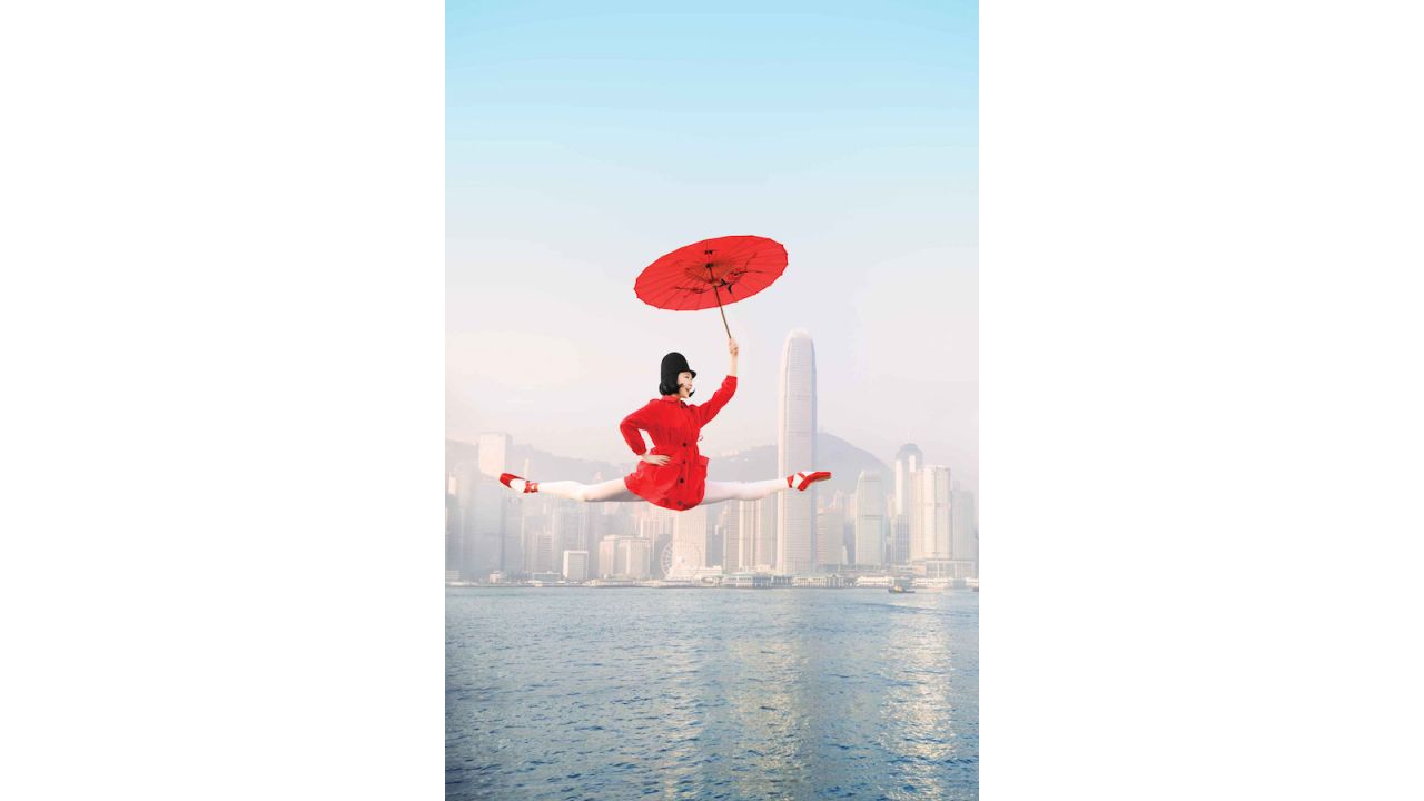<strong>Kowloon: </strong>Dancer Ye Feifei leaps into the sky, with Kowloon Island in the distance behind her. 