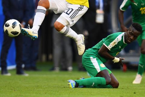 Colombia's Juan Quintero jumps over Senegal's Idrissa Gana Gueye. Senegal finished with four points in Group H, the same as Japan, but Japan advanced on the "fair play points" tiebreaker. Japan had two fewer yellow cards in the tournament than Senegal. 