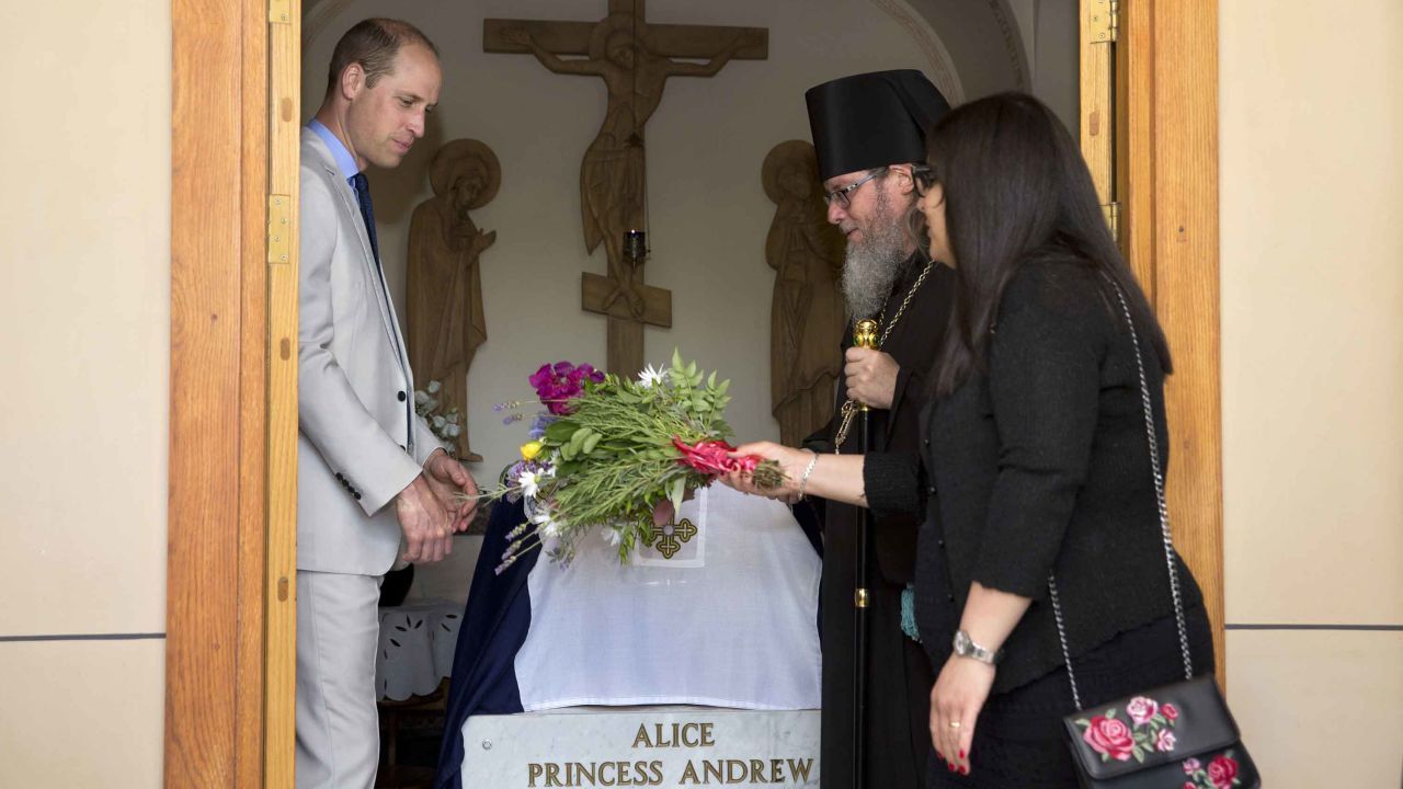 Britain's Prince William visits the grave of his great-grandmother, Princess Alice of Battenberg, during a visit to the Church of Mary Magdalene in Jerusalem on June 28, 2018.