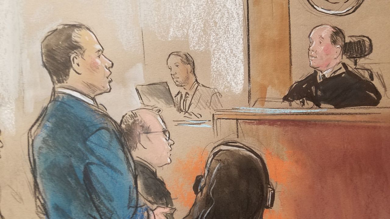 An attorney for an immigrant child appears before Judge John M. Bryant, the clerk next to him and the government attorney, Andrew Wagner, to the left of the immigrant attorney standing.