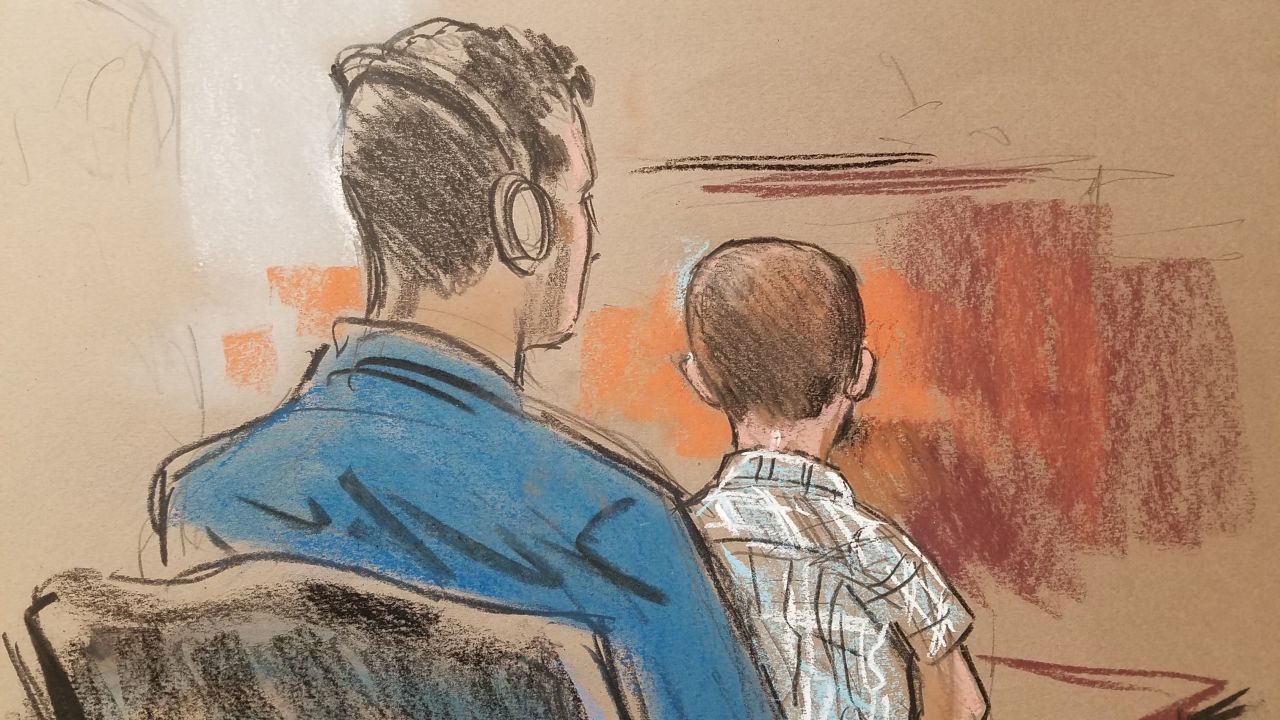 Every immigrant is provided headphones to listen to an interpreter's translation of what is being said in court. Here, 6-year-old Rodolfo, the youngest child in court this day, sits on his father's lap. As he did with most of the children, Judge Bryant asked Rodolfo if he was in school.