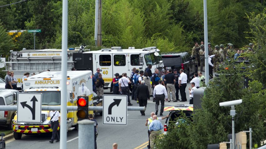 Authorities stage at the building entrance after multiple people were shot at The Capital Gazette newspaper in Annapolis, Md., Thursday, June 28, 2018. (AP Photo/Jose Luis Magana)
