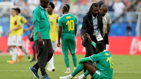 Mbaye Niang is consoled by coach Aliou Cisse at the final whistle.