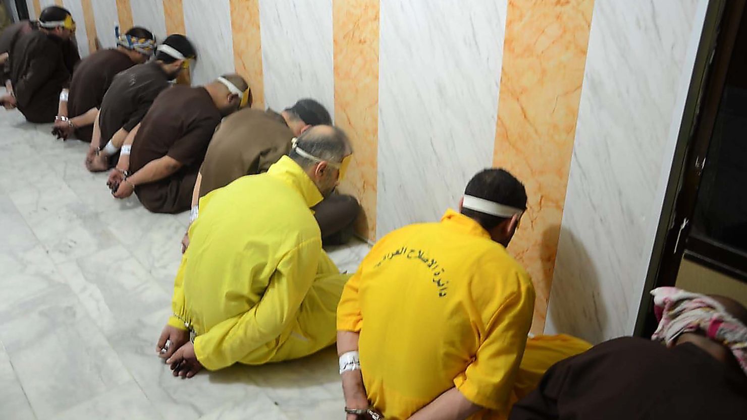 A handout picture released by the Iraqi Justice Ministry on Friday shows alleged ISIS fighters ahead of their execution. 