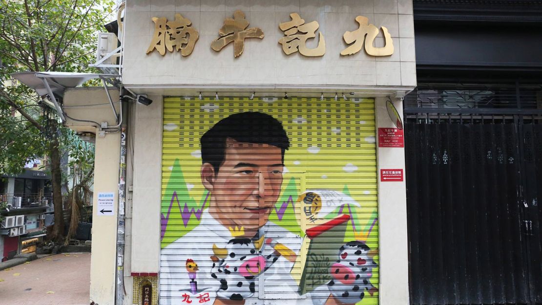 Local street art team Smile Maker painted an image of the owner of Kau Kee Restaurant onto the shop's shutter.