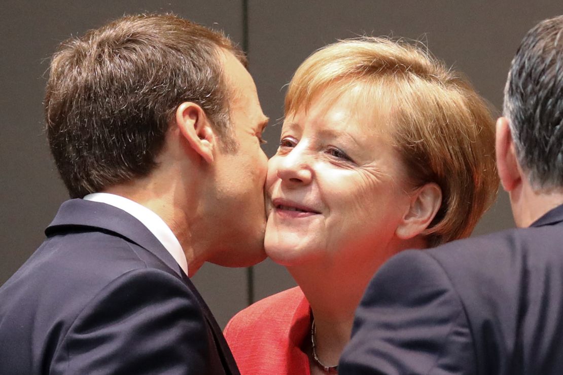 Emmanuel Macron kisses Angela Merkel during the last day of the European Union leaders' summit.