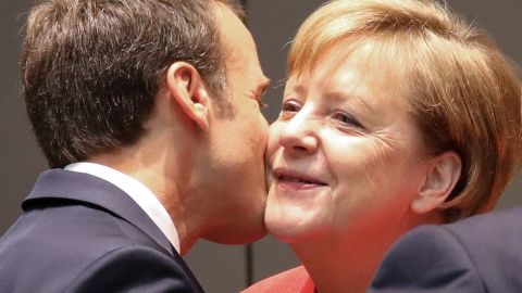 Emmanuel Macron kisses Angela Merkel during the last day of the European Union leaders' summit.