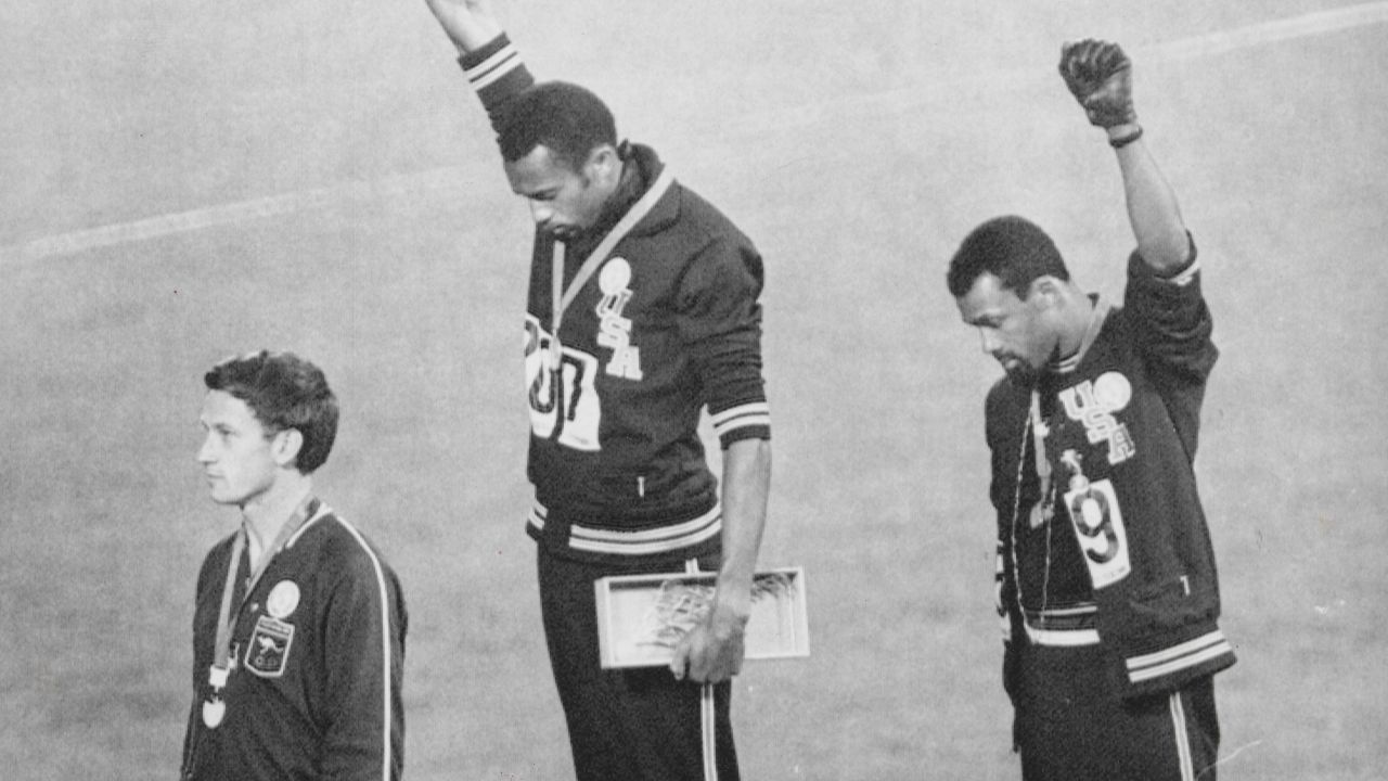 Tommie  Smith  and  John  Carlos raise their fists on the podium at the 1968 Olympics