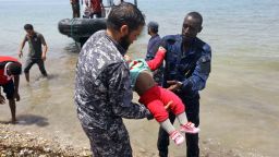 Members of the Libyan security forces carry the body of a young child ashore east of the capital Tripoli.