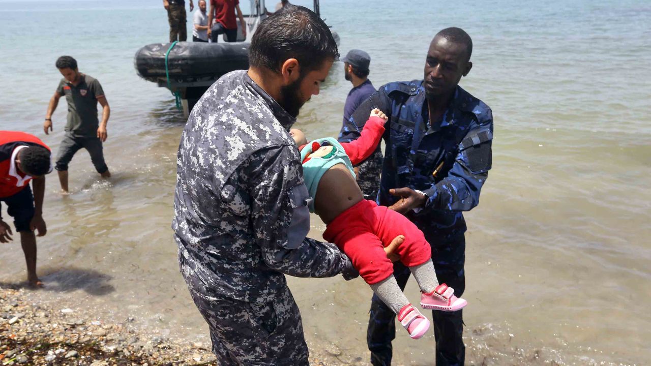 Members of the Libyan security forces carry the body of a baby ashore east of the capital Tripoli.