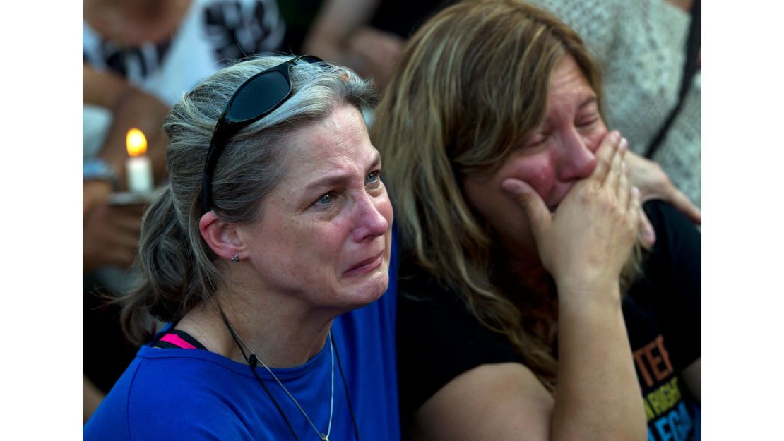 Carol Geithner, left, and Yasemin Jamison gather for a candlelight vigil in  Annapolis, Maryland.