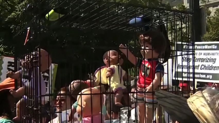 Protesters in Atlanta are carrying a dog crate with baby dolls inside