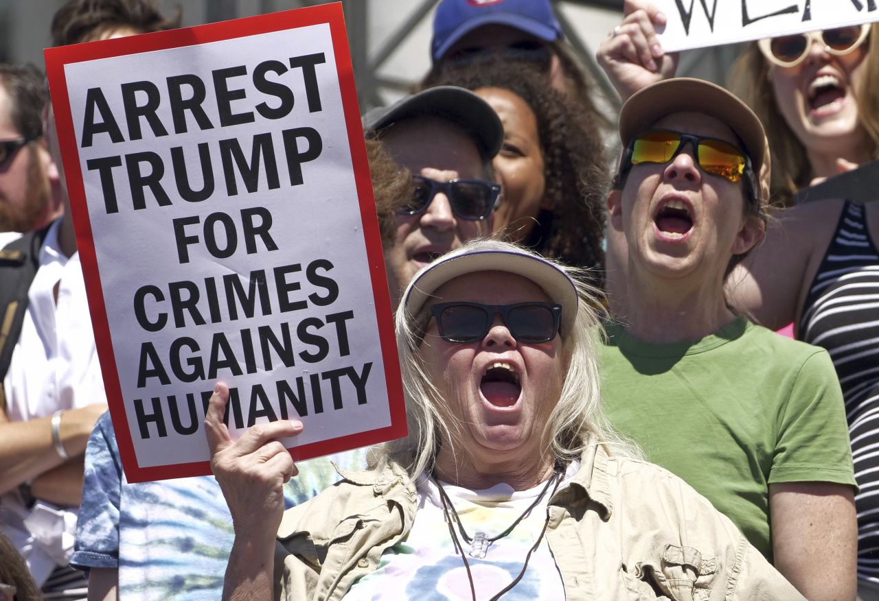 Salt Lake City: Activists hold signs Saturday to protest the Trump administration's approach to illegal border crossings and separation of children from immigrant parents.
