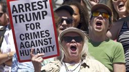 Activists hold signs to protest the Trump administration's approach to illegal border crossings and separation of children from immigrant parents Saturday, June 30, 2018, in Salt Lake City. (AP Photo/Rick Bowmer)