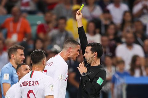 Portugal's Cristiano Ronaldo receives a yellow card from referee Cesar Ramos near the end of the match.