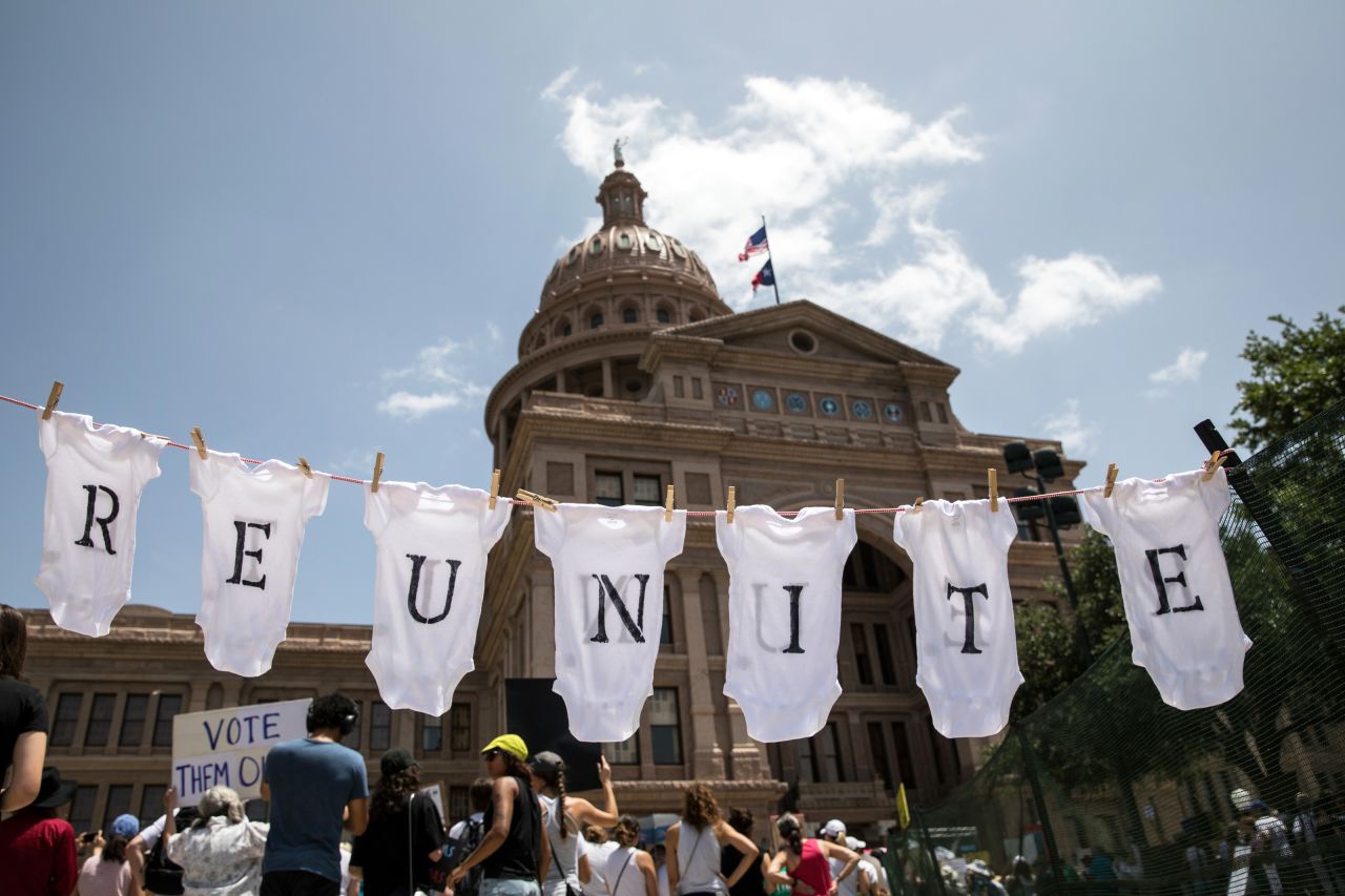 Austin, Texas: A demonstrator uses baby clothes to spell out the word "reunite" during a rally against the Trump administration's immigration policies outside the Texas Capitol. Demonstrations are being held in cities across the United States on Saturday to call for the reunification of separated families and to protest the detention of children and families seeking asylum at the border.