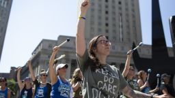 Demonstrators raise their fists during a protest against the Trump administration's policy on separating immigrant families at Foley Square in New York, U.S., on Sunday, June 30, 2018. Four cities, including New York, sought Friday to block a move by the U.S. Justice Department to modify a 1997 settlement on behalf of underage immigrants that prevents the government from locking up children captured crossing the border illegally with their family. Photographer: Cedric von Niederhausern/Bloomberg via Getty Images