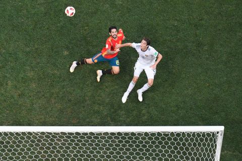Spain's Isco and Russia's Mario Fernandes vie for the ball.