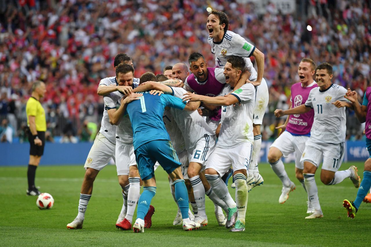 Russian players mob Akinfeev after the final save.