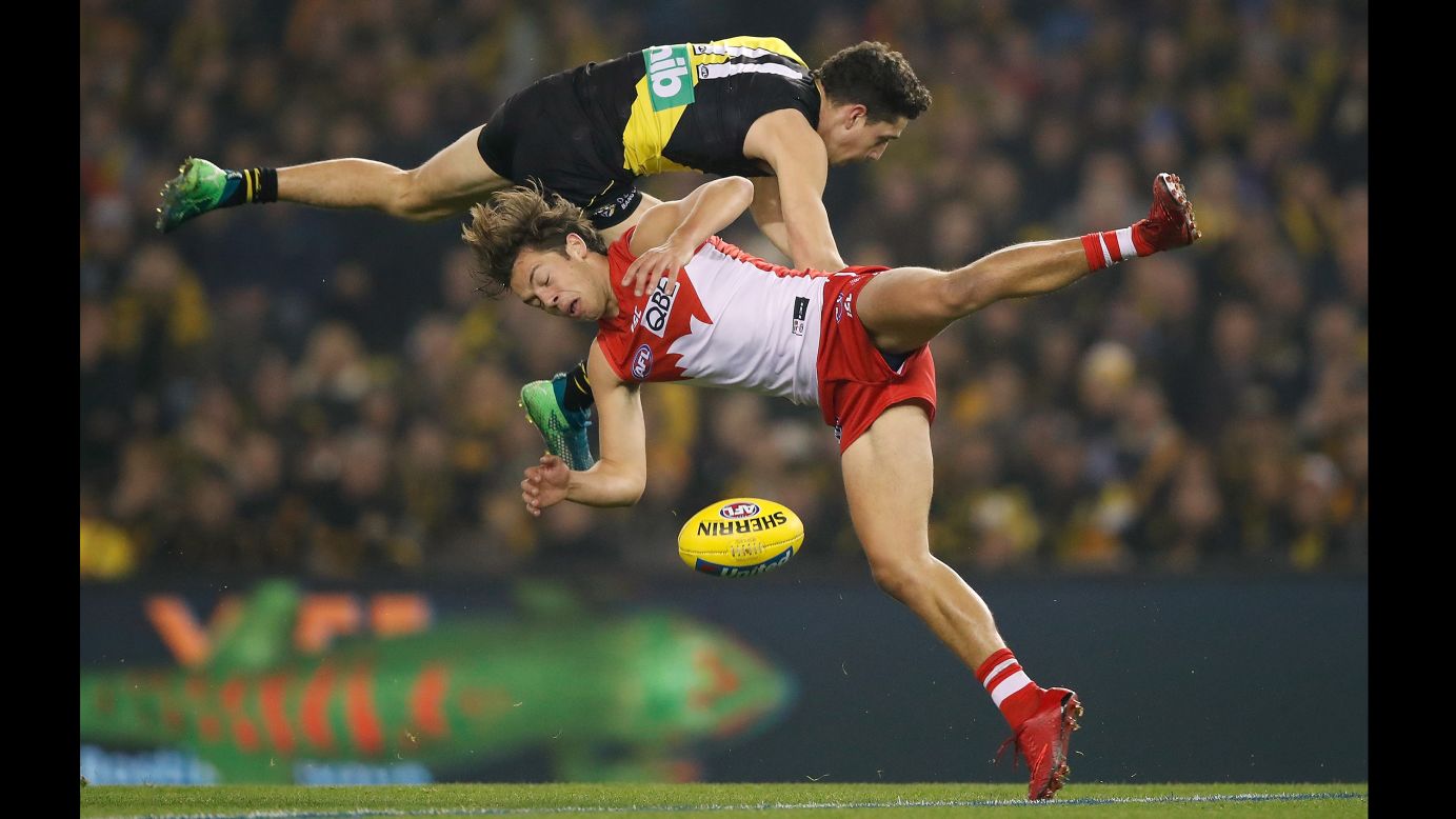 Jason Castagna of the Richmond Tigers collides with Oliver Florent of the Sydney Swans during their AFL match on Thursday, June 28, in Melbourne, Australia. The Tigers defeated the Swans in the round 15 match. 