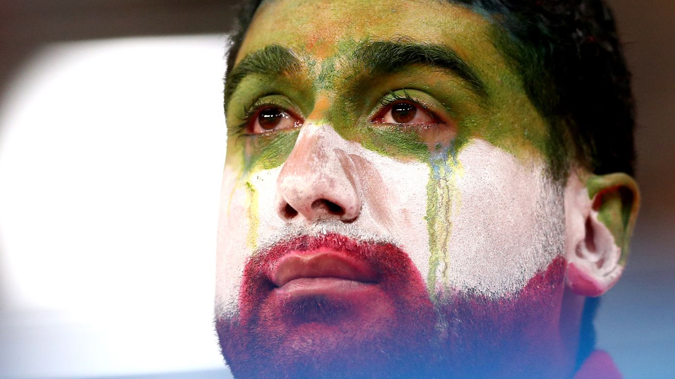 An Iran supporter gets emotional following a 1-1 draw with Portugal that knocked his team out of the World Cup on Monday, June 25.