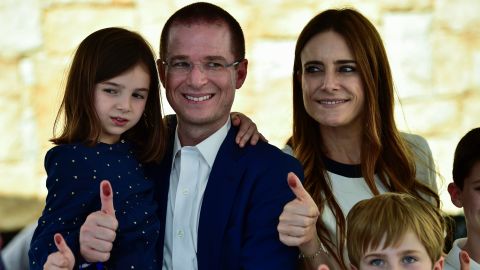 Ricardo Anaya and his family give their inked thumbs up after he cast his vote during in Queretaro.