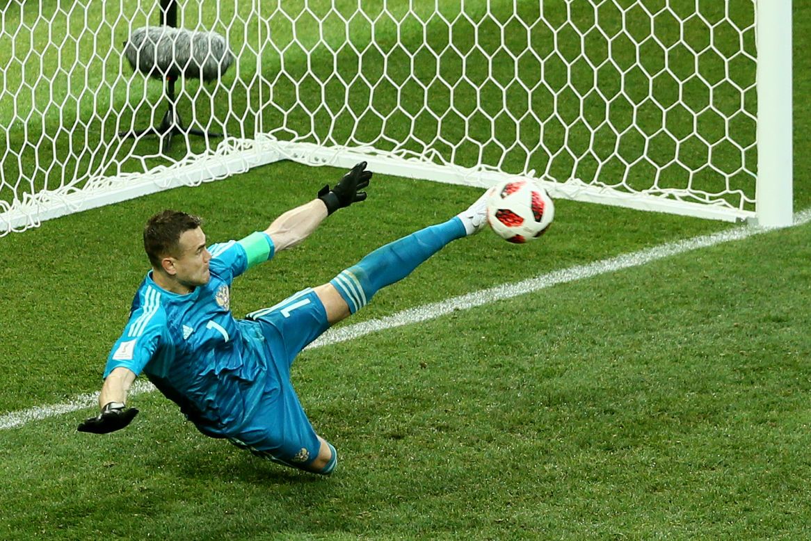 Igor Akinfeev of Russia saves the fifth penalty, taken by Iago Aspas of Spain, in the penalty shootout during the match between Spain and Russia on Sunday, July 1.