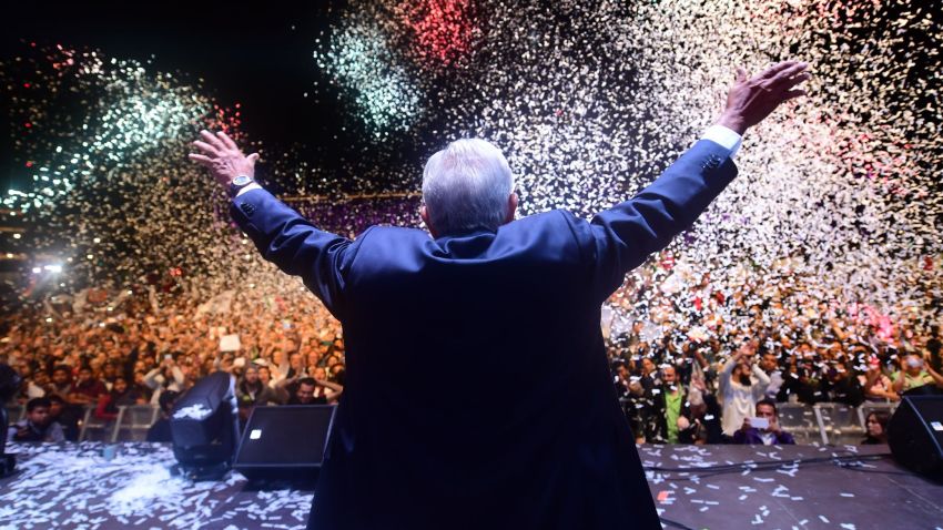 TOPSHOT - Newly elected Mexico's President Andres Manuel Lopez Obrador (C), running for "Juntos haremos historia" party, cheers his supporters at the Zocalo Square after winning general elections, in Mexico City, on July 1, 2018. (Photo by PEDRO PARDO / AFP)        (Photo credit should read PEDRO PARDO/AFP/Getty Images)