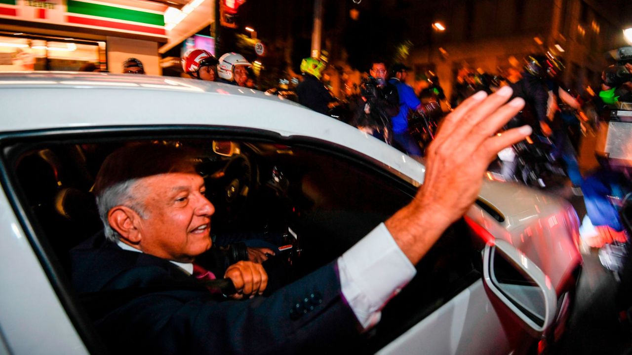 Andres Manuel Lopez Obrador waves to his supporters after his landslide victory.