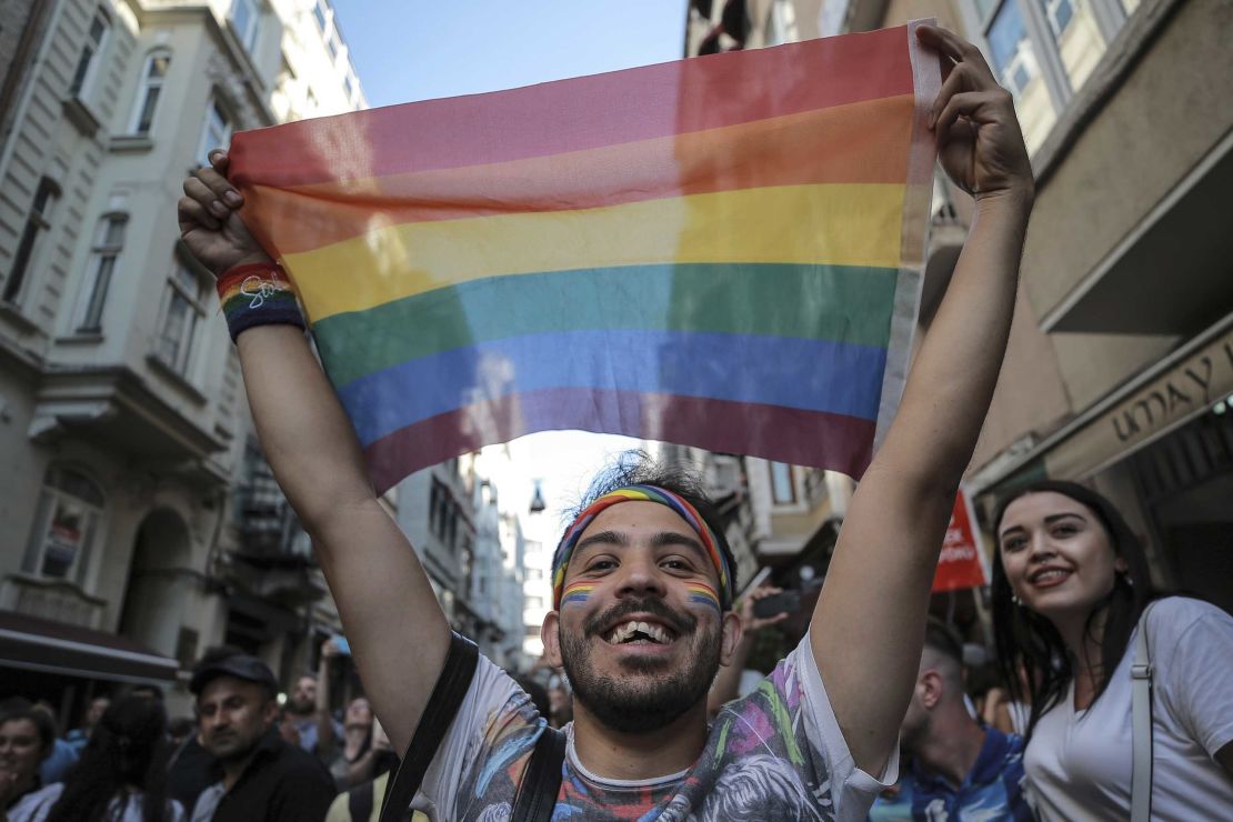 An activist brandishes a rainbow flag during the banned march. 