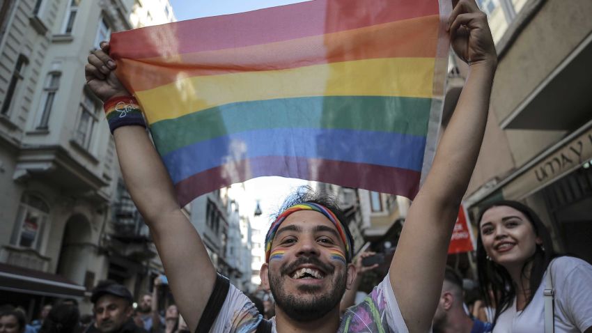 An activist brandishes a rainbow flag as Turkey's lesbian, gay, bisexual, trans and intersex activists march despite a ban, in Istanbul, Sunday, July 1, 2018.  The Istanbul LGBTI+ activists gathered in the city's Taksim neighbourhood after they announced Istanbul's local government had banned the Pride march for the fourth year in a row. (AP Photo/Emrah Gurel)