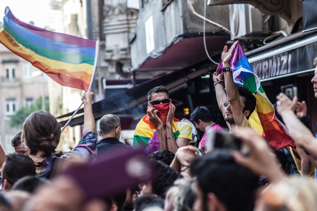 LGBTI activists shout slogans and hold rainbow flags in Instanbul's city center.