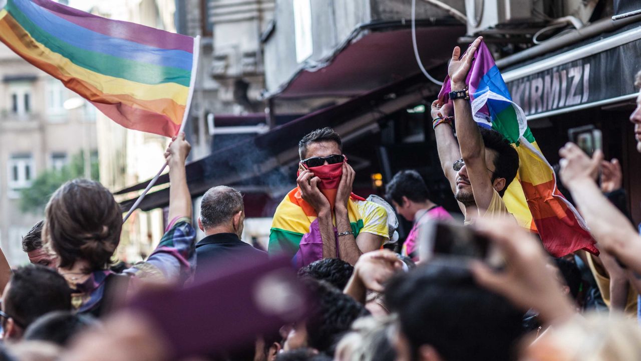 LGBTI activists shout slogans and hold rainbow flags in Instanbul's city center.