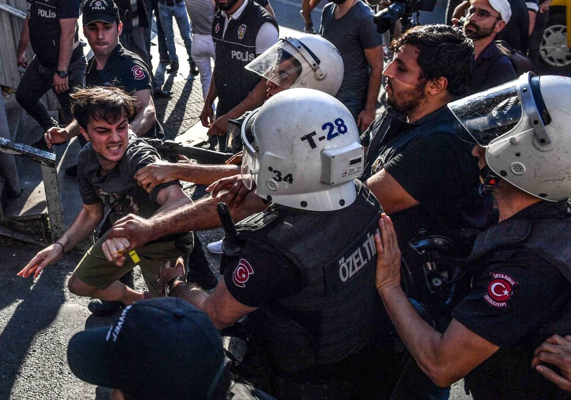 Officers scuffle with an activist during the march. 