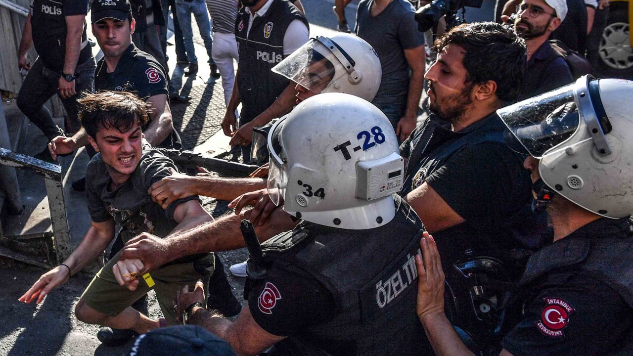 Officers scuffle with an activist during the march. 