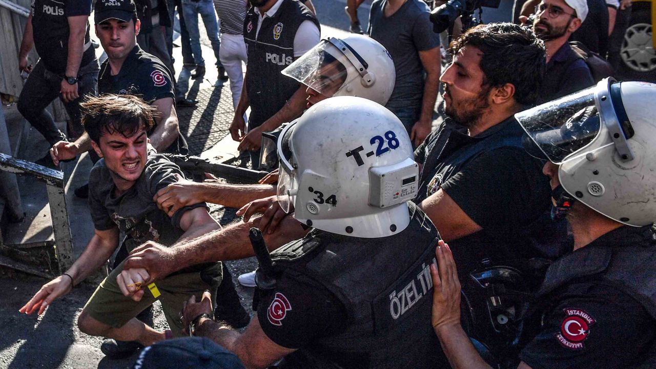 Officers scuffle with an activist during the march.