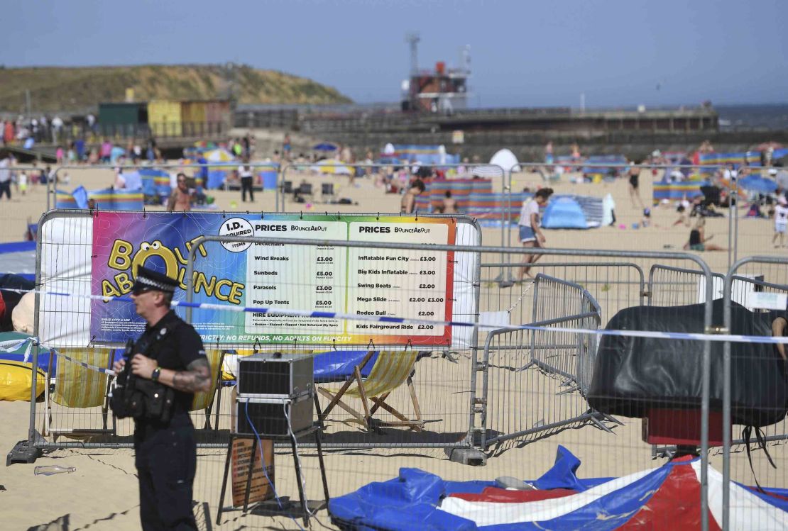 A police officer guards the cordoned-off area where the young girl was killed Sunday.