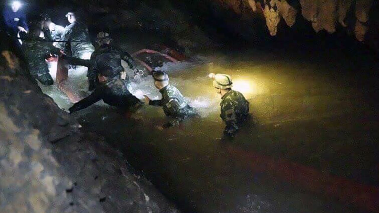 Thai rescue teams walk inside cave on Monday, July 2.