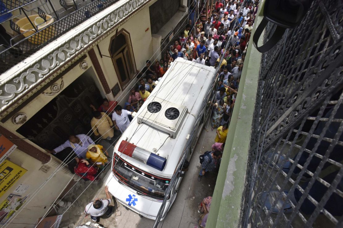 An ambulance is seen exiting the scene of the alleged murder, in Burari, a predominately low-income neighborhood in North Delhi.  