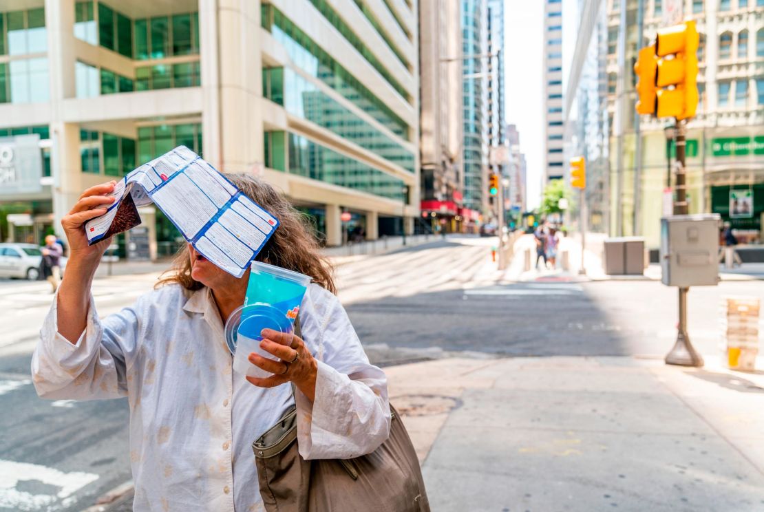 A woman tries to shield herself from the sun in Philadelphia, Pennsylvania.