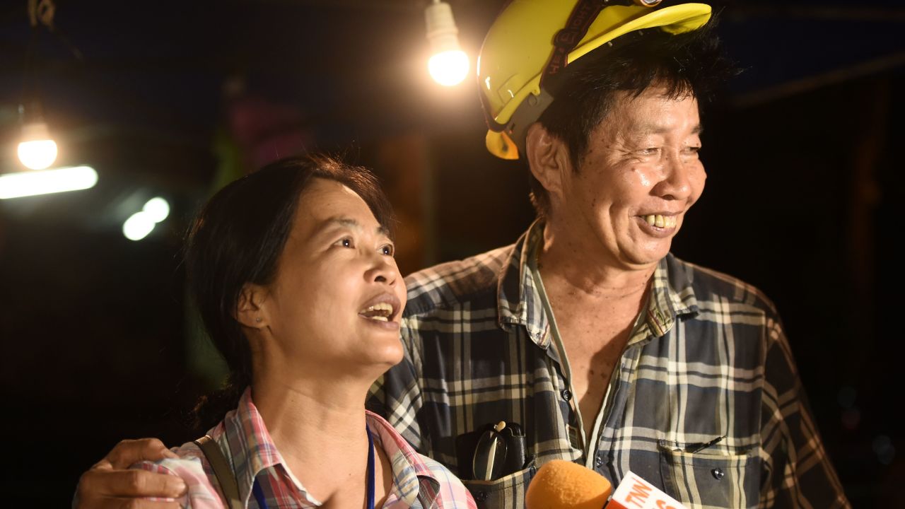 Family members celebrate after hearing everyone trapped in the cave is alive.